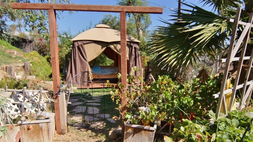 Outdoor bedroom in a garden with a gazebo 