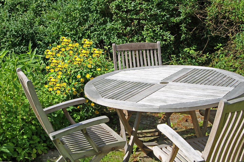 old teak chairs and round table