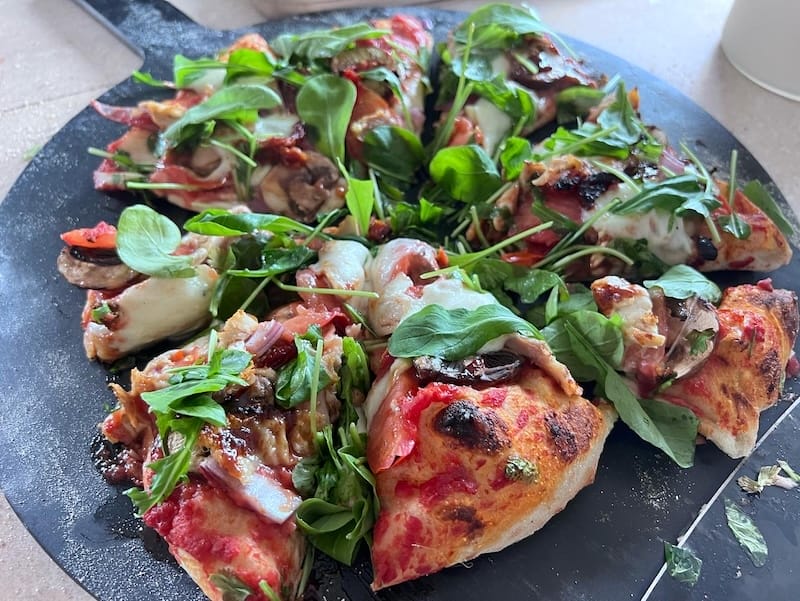 pizza topped with fresh arugula
